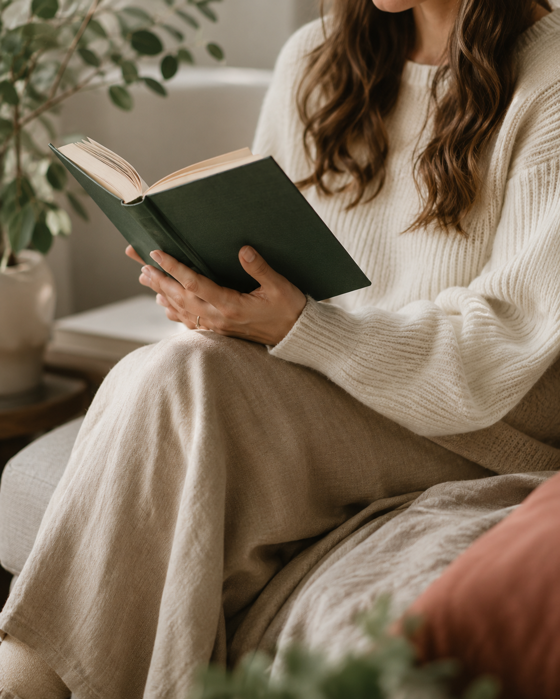 Mujer de pelo largo sentada, leyendo un libro